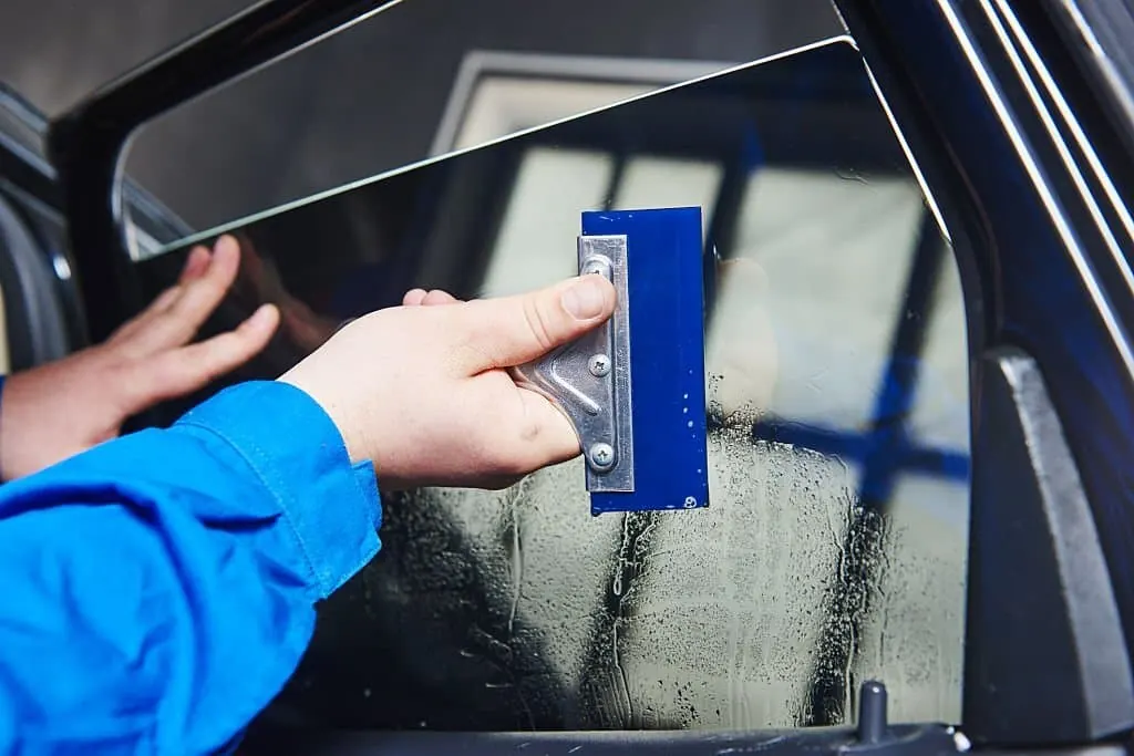 Window tint film being installed on a car side window
